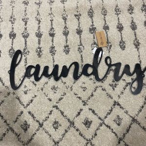 Black metal “laundry” sign